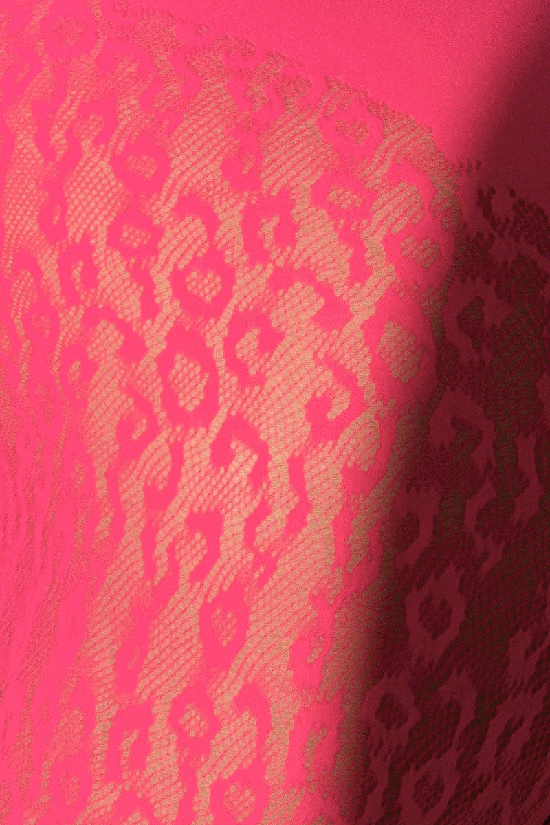 Close-up of hot pink sheer leopard pattern knit fabric on seamless crop top and leggings set